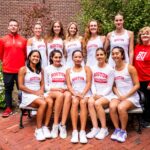 Photo: The BU Women's Tennis team poses for a team photo, with players in uniform and coaches at their sides