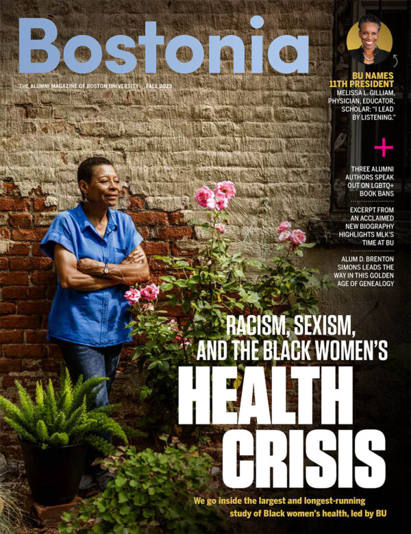 Image: Cover of the Bostonia Fall 2023 Magazine Issue. Cover features a photo of Photo: Kim Bressant Kibwe, an older Black woman with short, black hair and wearing a blue, button-up collared shirt smiles and looks to the right as she poses in front of a brick wall. A blurred pink flower is shown in the foreground. Large white text features the titles of the various feature stories. "Bostonia" is also displayed prominently in light blue color.