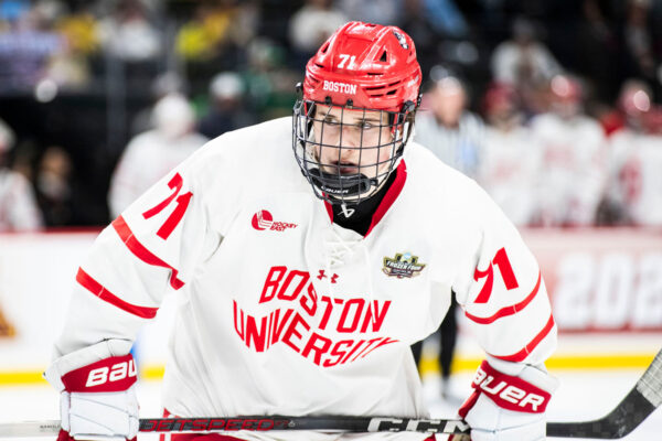 Photo: A college hockey player at Boston University wearing a red and white jersey and red helmet, on ice at a recent game.