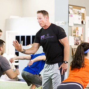 Personal trainer Walter Norton, Jr. working with high school students at Institute of Performance and Fitness