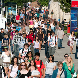 Students walk along Commonwealth Avenue on the Boston University Charles River Campus