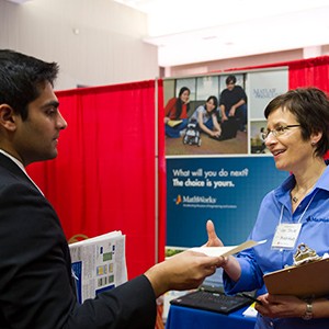A student speaking with a host a the BU's Center for Career Development career fair