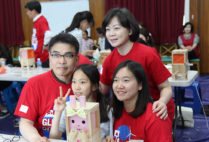 Young-chun Cho (clockwise from top left) his wife, Soojeong Kim, and their daughter Hyunjoo Cho work with an orphan from Dream Tree Village at a Global Days of Service event last year.