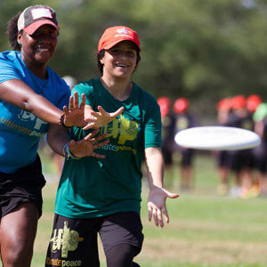 Dana Dunwoody with youth reaching for mid-air disc