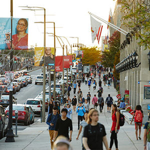 Students walk along Commonwealth Ave. on the Boston University Charles River Campus