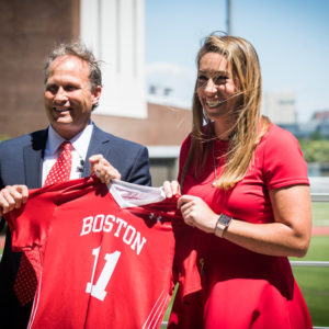 Drew Marrochello, BU athletics director, welcomed Lauren Morton (CAS’08) as BU’s new women’s lacrosse coach with a jersey featuring her number from her University playing days. Photo by Jackie Ricciardi