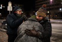 A City of Boston volunteer hugs a homeless person during the annual Boston Homeless Census.