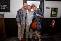 Taylor swift poses with the happy couple