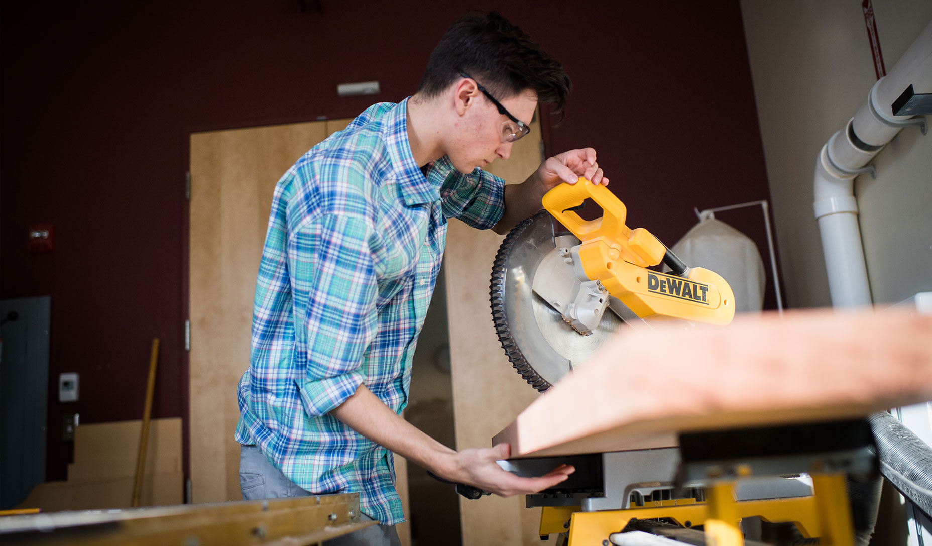 Woodworker Justin Fiaschetti uses a saw in the Fiaschetti Woodworking workshop.