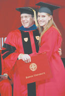 BU trustee Kenneth Feld (SMG'70), chairman and CEO of Feld Entertainment Inc., presents a diploma to his daughter, Alana Michele Feld (COM'02), at the College of Communication convocation on May 19. Photo by Michael Hamilton