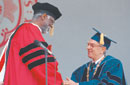 Bill Russell accepts his honorary degree from Jon Westling. Photo by Albert L'Étoile