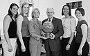 The BU women's basketball team made its first-ever trip to the NCAA tournament this spring and presented a signed ball from its opening round game, against UConn (which later won the championship), to Provost Dennis Berkey, a dedicated supporter of both the team and Head Coach Margaret McKeon, who enters her fifth season at the University this fall. From left are guard Katie Terhune (CAS'04), who was selected as BU's Female Athlete of the Year, forward Adrienne Norris (CAS'05), McKeon, Berkey, forward Marisa Mosley (CAS'04), and guard Katie Meinhart (SMG'06). Photo by Kalman Zabarsky