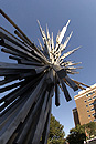Explosion. Sergio Castillos metal sculpture is orbited in this shot by several BU buildings (clockwise from upper right): the graduate housing at 580 Commonwealth Ave., the School of Management, Morse Auditorium, the Physics Research Building, and the Metcalf Center for Science and Engineering. This photo was taken on September 27, using a digital camera with a fish-eye lens laid upon the sculptures base. Photo by Kalman Zabarsky