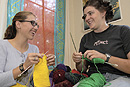 BU Knitting Club founders Agnes Gyorfi (CAS06) (left) and Brenna Rutherford (SAR06) take a study break by breaking out the needles in Gyorfis residence hall room. Photo by Fred Sway