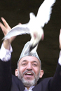 Afghan President Hamid Karzai releases a dove during the Afghanistan Independence Day ceremony in Kabul onAugust 19, 2002. AP Photo/Kamran Jebreili