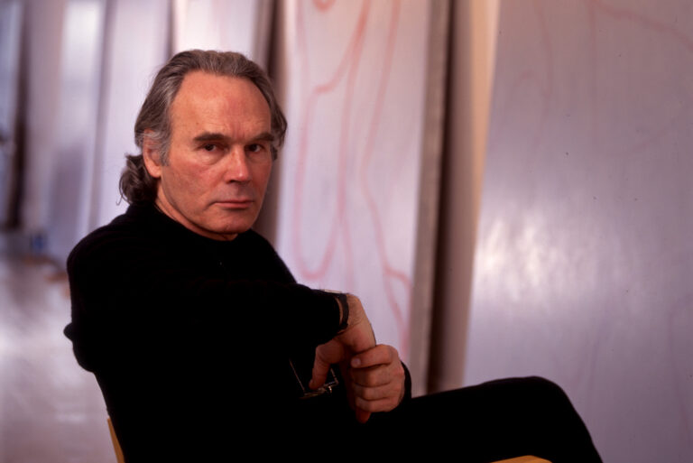 Painter Brice Marden sitting down on a chair in his studio in New York City.