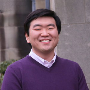 Headshot of Jonathan in a purple sweater outdoors