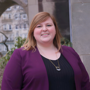 Headshot of Chloe in a purple blazer outdoors