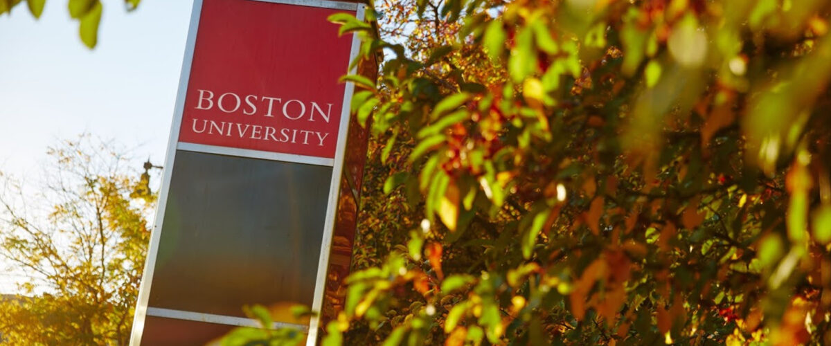 Boston University sign behind leaves