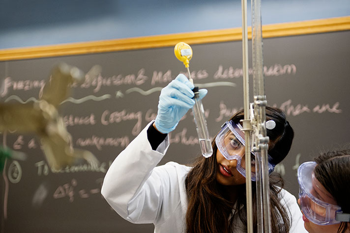 Krishna Singh (CAS’18) checks the liquid in a test tube as her lab partner Natalya Shelchkova (CAS’18) looks on during a chemistry lab on Thursday, February 26, 2015
