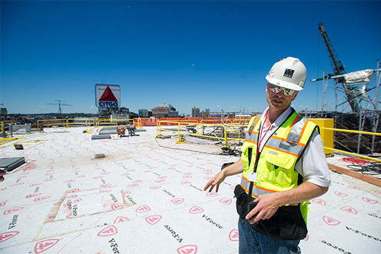 Al Hartshorn, Shawmut Design and Construction senior project superintendent, stabds on Myles Standish Hall new roof
