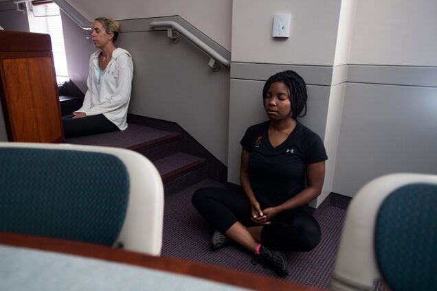 Lani Silversides and Shana Jones meditating in classroom