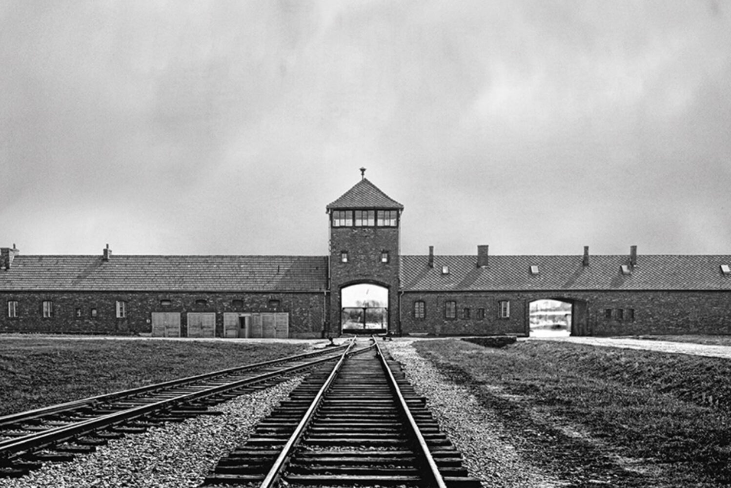 Photo: Train tracks leading to the entrance of Auschwitz.