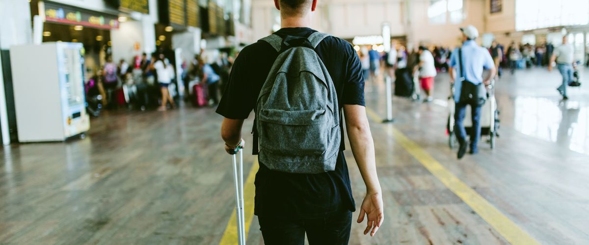Young man walking in the airport.