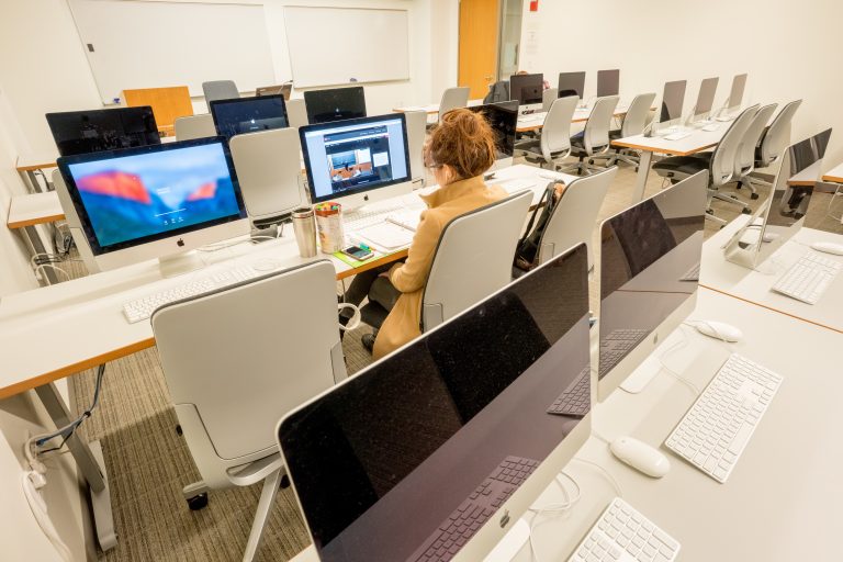 Students focused in a computer lab on campus