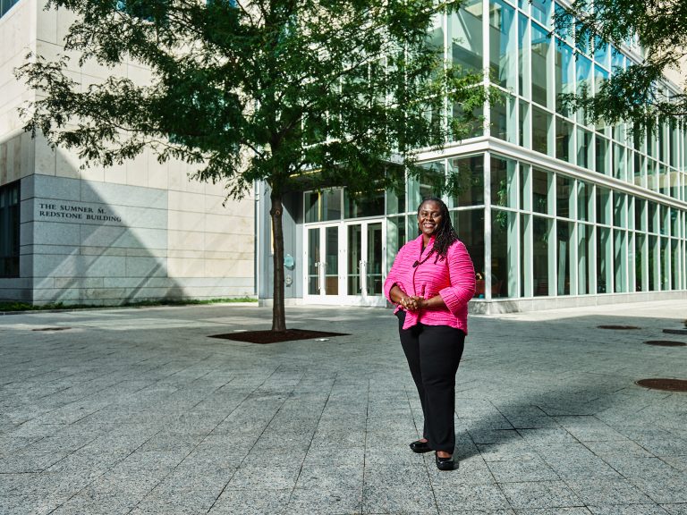 Dean Angela Onwuachi-Willig stands in front of the Sumner M. Redstone building