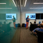 Rudolph Pienaar stands at the front of a conference room at the ChRIS Code Lab, explaining how ChRIS works.