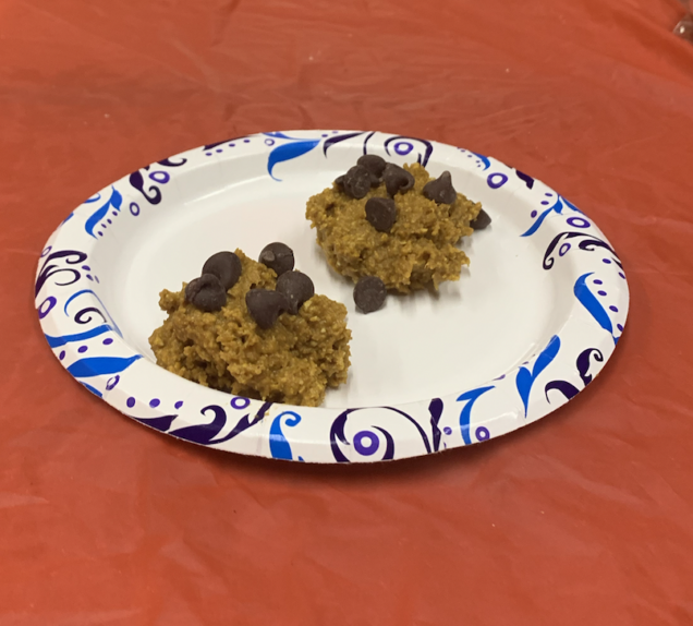 To show two pumpkin cookies served on a plate