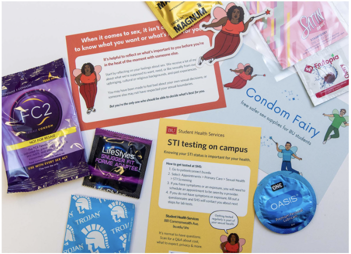 An assortment of safer sex supplies, Condom Fairy stickers, and educational materials