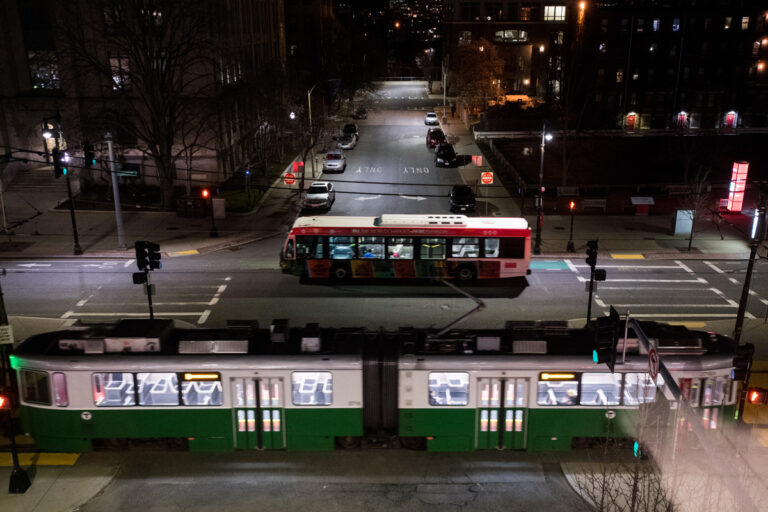 Night time overhead view of the T and BU bus passing