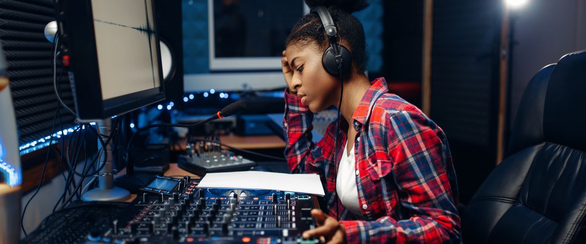 Female sound operator in audio recording studio