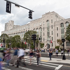 Students cross Commonwealth Ave on the Boston University Charles River Campus