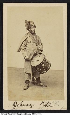 Johnny Pell dressed in blackface holding a drum