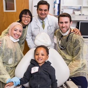Patient Levi McBride with (from left) Yasmin Alayyoubi, Dolrudee Jumlongras, Athanasios Zavras, and Stephen Prieve