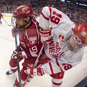 Clayton Keller fights for the puck up against the boards in Boston University's 6-3 loss to Harvard in the 65th Annual Beanpot Final