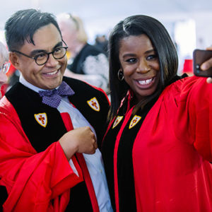 Orange is the New Black cast member Uzo Aduba takes a photo with students at the Boston University College of Fine Arts convocation, part of the 144th BU Commencement