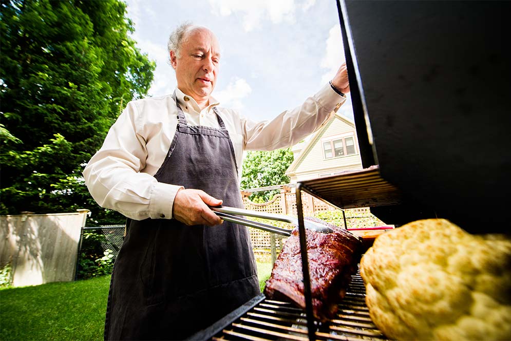 Greg Blonder, professor at Boston University College of Engineering, cooks pork ribs at his home.