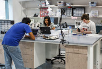 People work in the Design, Automation, Manufacturing, Prototyping lab (DAMP lab) at the Rajen Kilachand Center for Integrated Life Sciences and Engineering science building at Boston University
