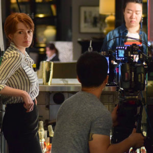 Lead actress Natalie Hebert gets into position during a shoot for The Bartender. In the background, Ran Shan (COM’ 18), prepares the scene. Photos by Kristian Lewis