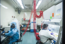 Infectious disease researchers Elke Mühlberger (left) and Adam Hume conduct BSL-4 research at Boston University's National Emerging Infectious Diseases Laboratories (NEIDL).