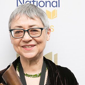 Sigrid Nunez poses for a photo holding her National Book Award.