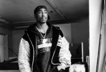 A black and white portrait of Tupac