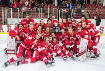 The BU women's ice hockey team poses with the Beanpot Trophy after winning the 41st Annual Beanpot Tournament Championship.