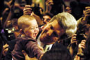 John Kerry holds six-month-old Rayna Ross after speaking at Daniel Webster College in Nashua, N.H., on January 21. Photo by Ed Wozniak (COM04)