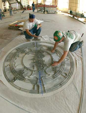 Sealed and delivered. Workers from Port Morris Tile and Marble install the BU seal in the lobby of the Agganis Arena on September 23. Theyre preparing to pour into a metal form an epoxy called terrazzo, which is made of marble chips. Photo by Vernon Doucette