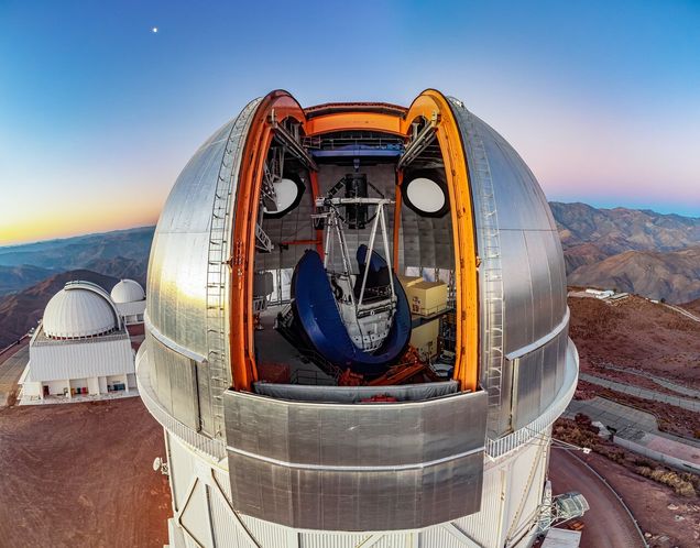 The Víctor M. Blanco 4-meter Telescope has pristine access to wide open skies of the Chilean Andes from its perch at Cerro Tololo Inter-American Observatory (CTIO), a Program of NSF’s NOIRLab. To the upper left of the telescope is the ‘evening star’, actually the planet Venus. Below on the left are the SMARTS 1.5-meter Telescope and SMARTS 0.9-meter Telescope (furthest back). Housed within the silver dome of the Blanco Telescope is the Dark Energy Camera (DECam), mounted at the prime (first) focus near the top of the white Serrurier truss. The blue U-shaped structure holding the truss is the large bearing that sweeps the telescope around to a designated position for observing. DECam saw first light on 12 September 2012 and in its more than 10 years of operation it has contributed greatly to the field of astronomy. It was designed specifically for the Dark Energy Survey, operated by the Department of Energy and the National Science Foundation between 2013 and 2019. During this time, DECam cataloged nearly 1 billion objects, helping to construct the largest ever map of the night sky. This photo was taken as part of the recent NOIRLab 2022 Photo Expedition to all the NOIRLab sites. Credit: CTIO/NOIRLab/NSF/AURA/T. Matsopoulos